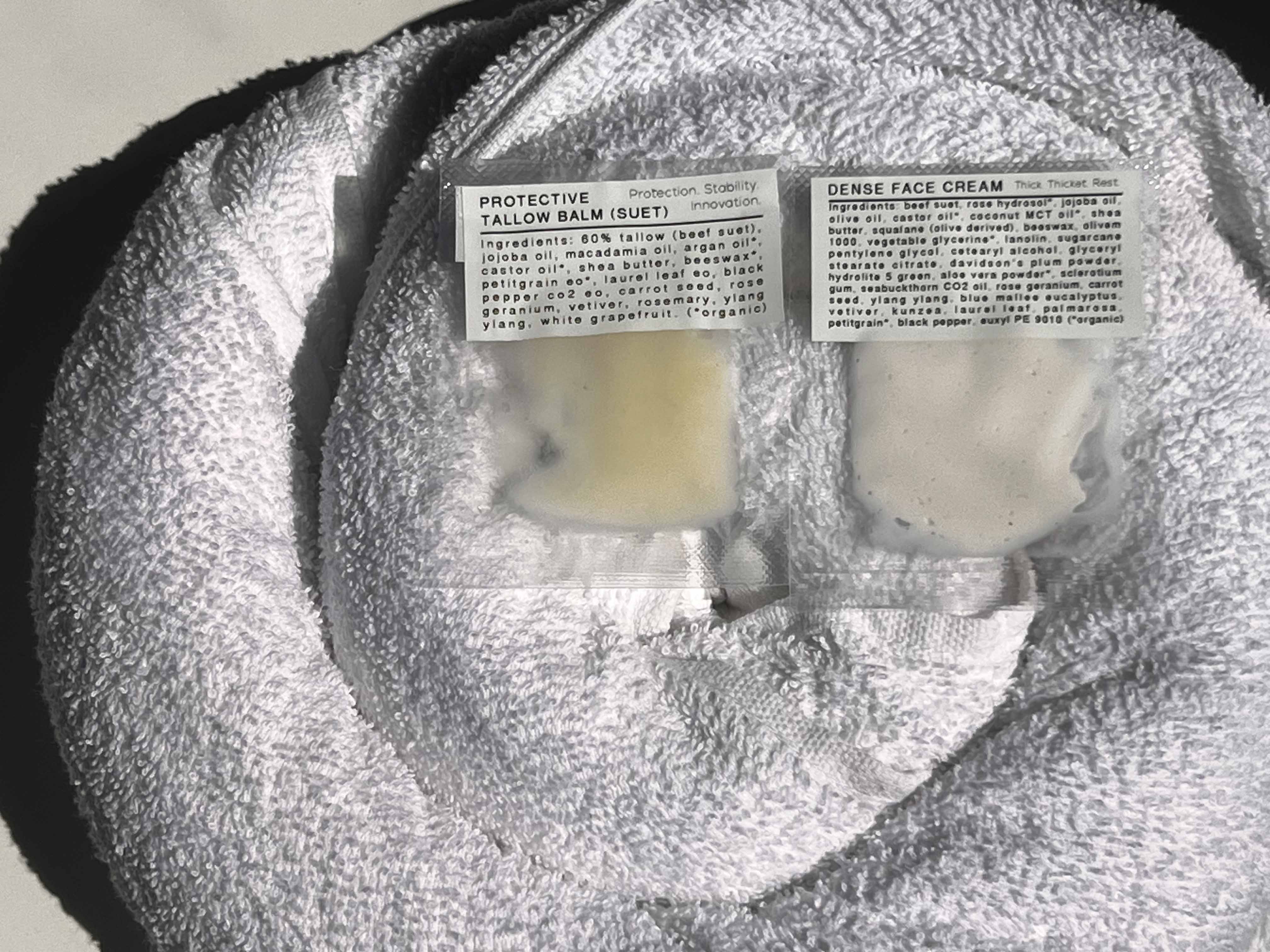 guest face cream satchels on a towel.